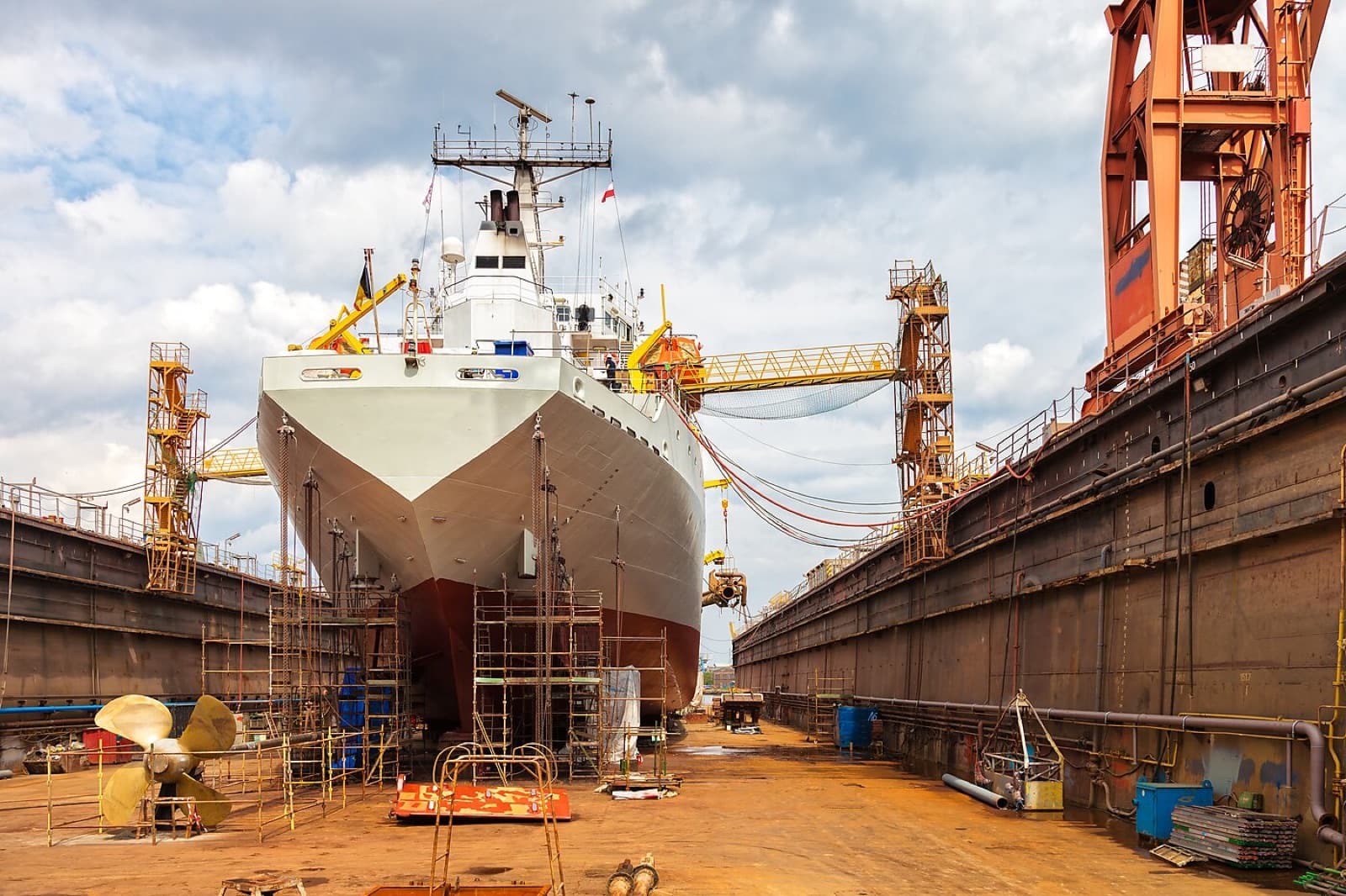 Naval vessel under construction in a shipyard dry dock